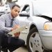 Claims adjuster inspecting a car with full coverage following an accident