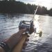 man extending a fishing rod in a utah lake