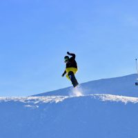 snowboarder taking air off a jump in utah