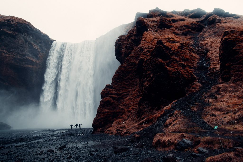 waterfall with people at the bottom